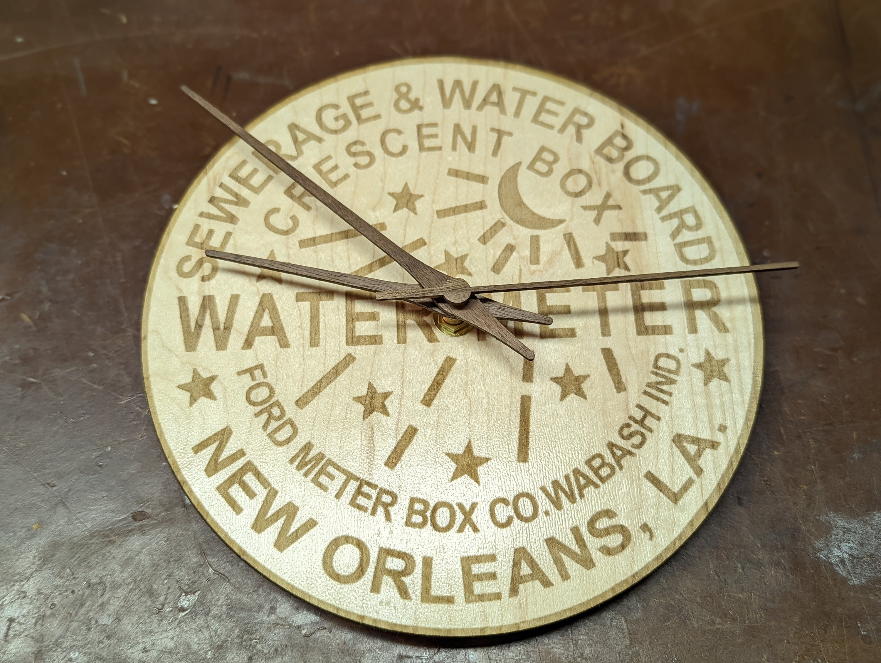NOLA water meter cover wall clock — laser engraved wood